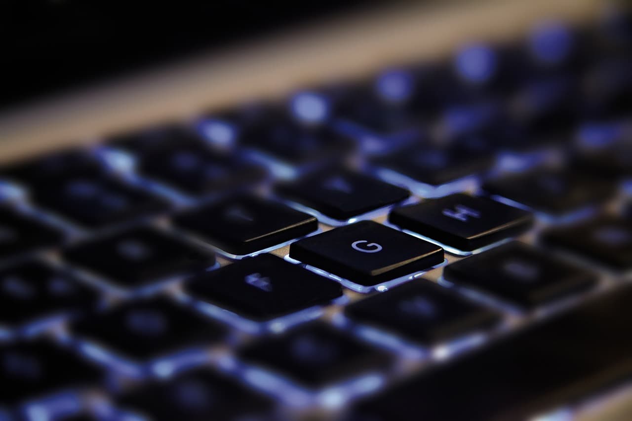A closeup of a black, backlit keyboard.